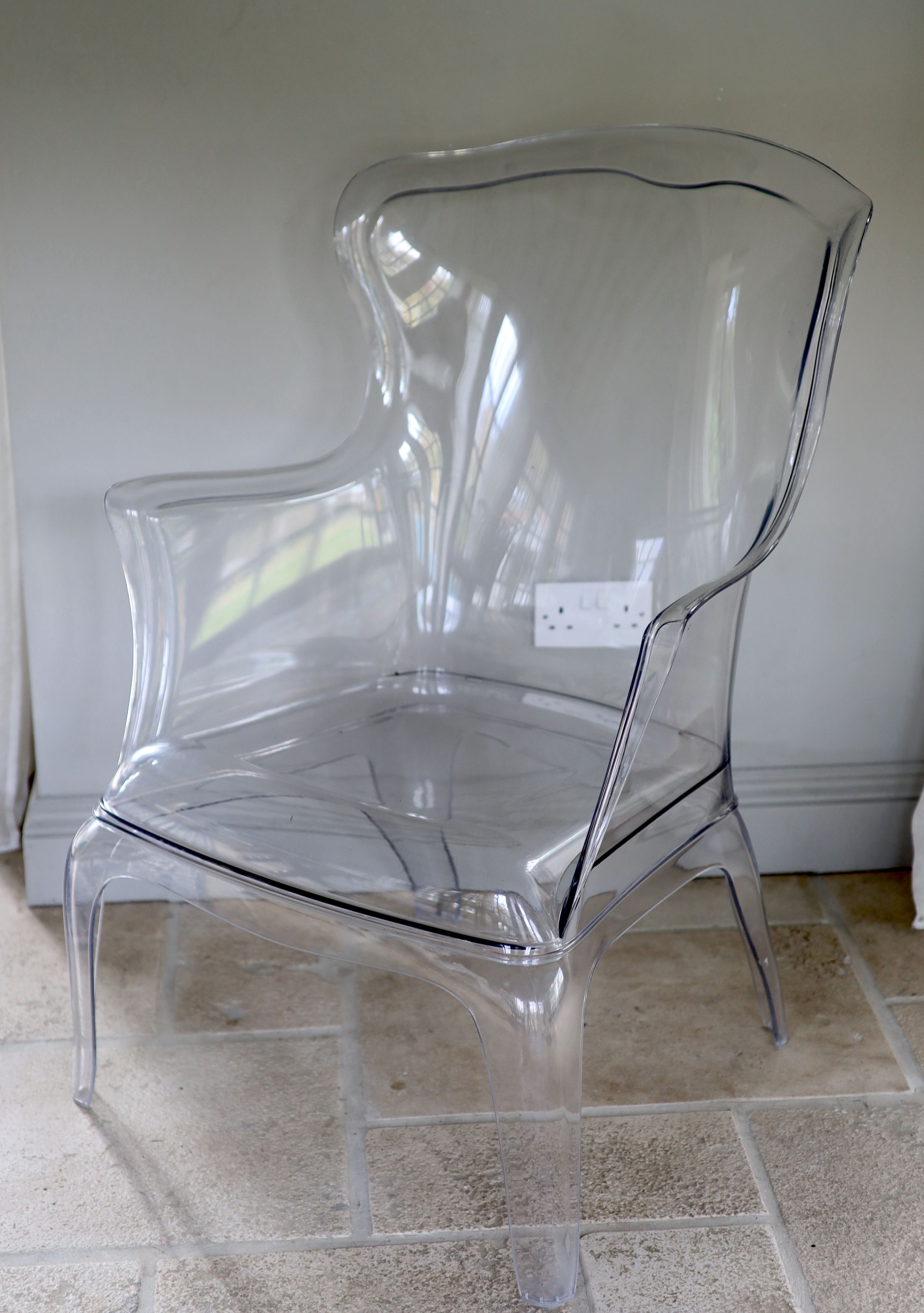 A perspex ghost chair, width 71cm height 98cm